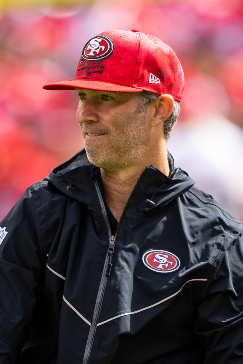 Nick Sorensen stands on the sideline with a hat